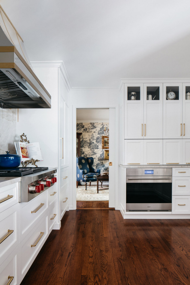 Example of a large transitional dark wood floor and brown floor kitchen pantry design in Chicago with recessed-panel cabinets, white cabinets, quartzite countertops, beige backsplash and beige countertops