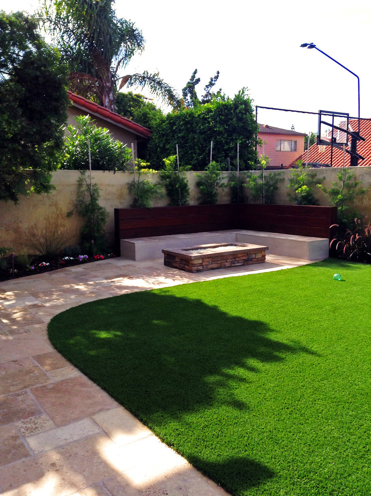 Mid-sized transitional backyard concrete patio photo in Orange County with a fire pit and no cover