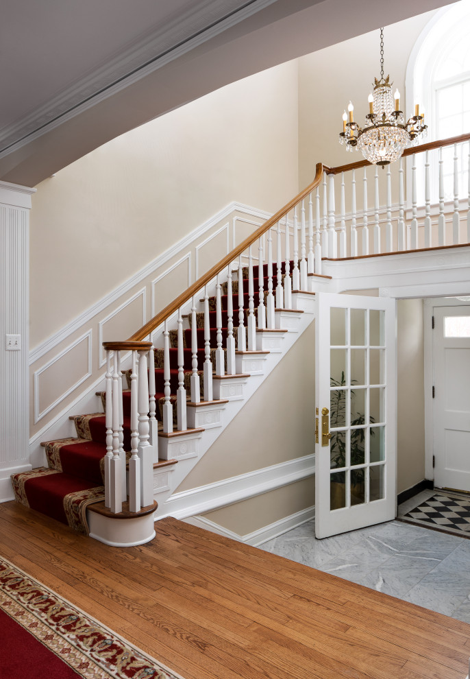 Design ideas for an expansive traditional entryway in DC Metro with beige walls, carpet and brown floor.