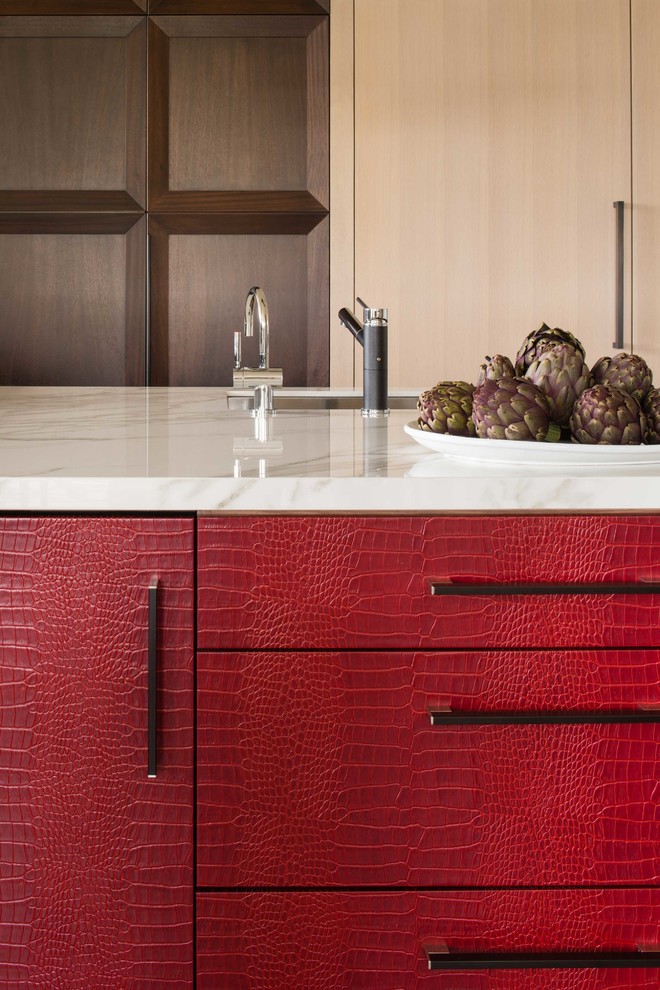 Mid-sized trendy l-shaped light wood floor and brown floor eat-in kitchen photo in DC Metro with an undermount sink, flat-panel cabinets, red cabinets, marble countertops, white backsplash, marble backsplash, stainless steel appliances and an island
