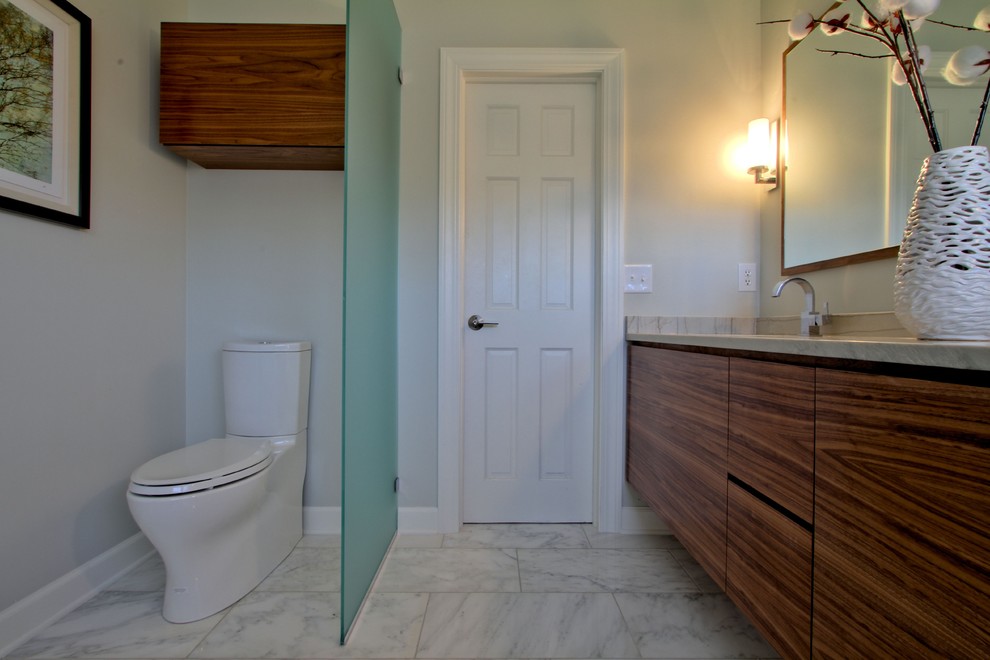 Photo of a contemporary bathroom in Indianapolis with an undermount sink, flat-panel cabinets, medium wood cabinets, quartzite benchtops, a two-piece toilet, white tile and stone tile.