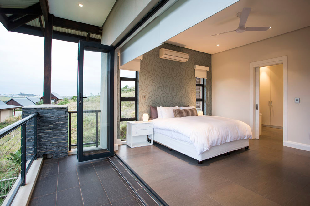 This is an example of a contemporary bedroom in Other with grey walls.