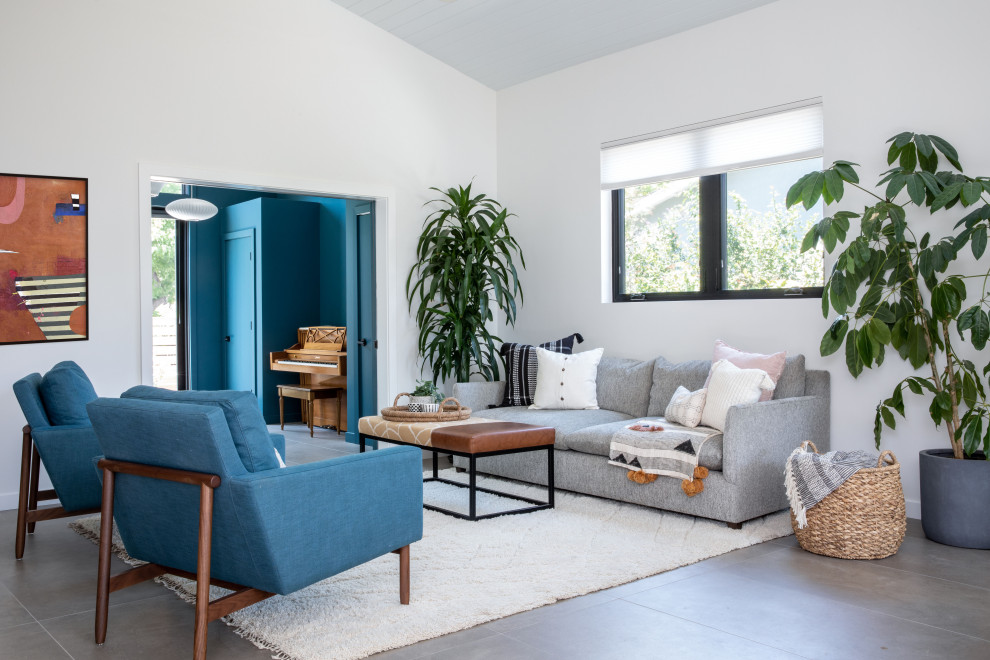 This is an example of a mid-sized midcentury formal open concept living room in San Francisco with white walls, porcelain floors, no fireplace, a built-in media wall, grey floor and exposed beam.