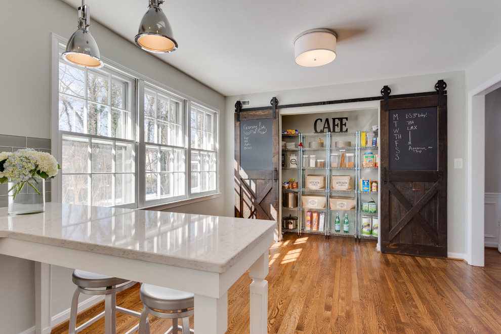 This is an example of a country kitchen in DC Metro with medium hardwood floors.