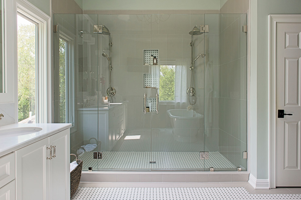 This is an example of a large master wet room bathroom in Nashville with beaded inset cabinets, white cabinets, a freestanding tub, a one-piece toilet, beige tile, porcelain tile, blue walls, mosaic tile floors, an undermount sink, engineered quartz benchtops, white floor, a hinged shower door, white benchtops, an enclosed toilet, a double vanity and a built-in vanity.