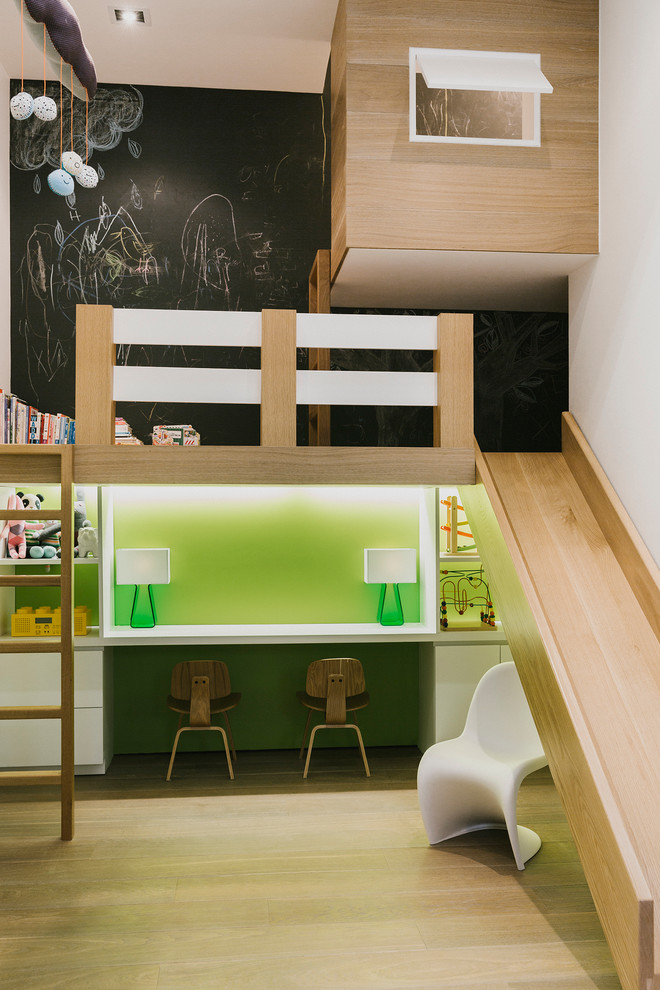 This is an example of a large contemporary gender-neutral kids' playroom for kids 4-10 years old in New York with black walls, light hardwood floors and beige floor.