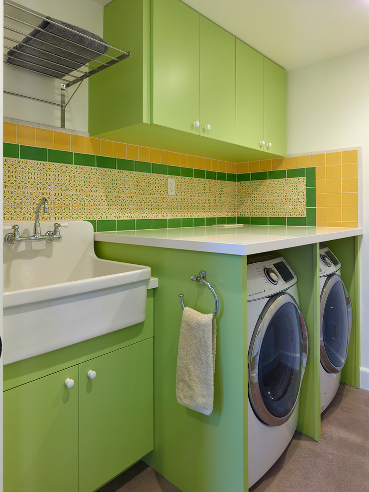 Mid-sized contemporary single-wall dedicated laundry room in San Francisco with an utility sink, flat-panel cabinets, green cabinets, quartz benchtops, white walls, concrete floors, a side-by-side washer and dryer, grey floor and white benchtop.