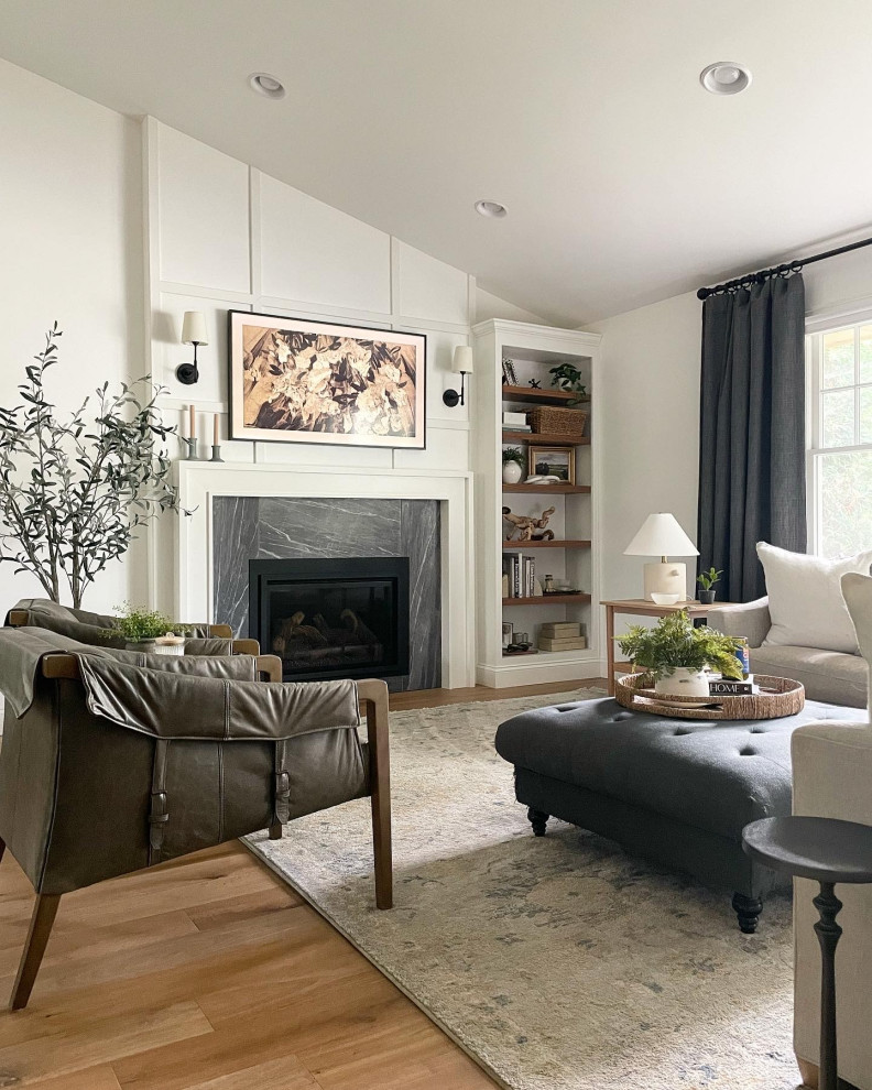 Photo of a large modern formal open concept living room in Los Angeles with white walls, medium hardwood floors, a standard fireplace, a stone fireplace surround, no tv, multi-coloured floor, recessed and planked wall panelling.