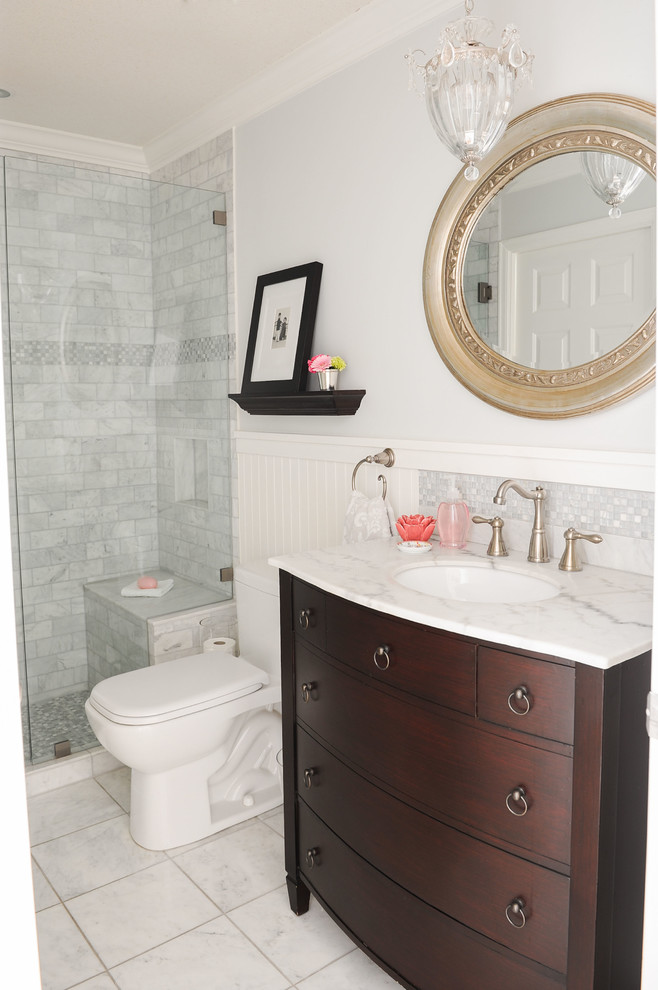 Design ideas for a small traditional 3/4 bathroom in Vancouver with furniture-like cabinets, dark wood cabinets, a one-piece toilet, gray tile, subway tile, grey walls, marble floors, an undermount sink, marble benchtops and a curbless shower.