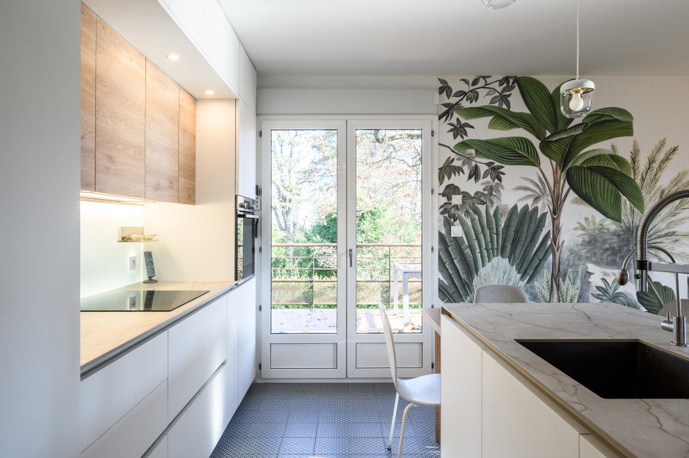 Photo of a mid-sized contemporary open plan kitchen in Lyon with an integrated sink, beaded inset cabinets, white cabinets, laminate benchtops, white splashback, panelled appliances, cement tiles, with island, green floor and grey benchtop.