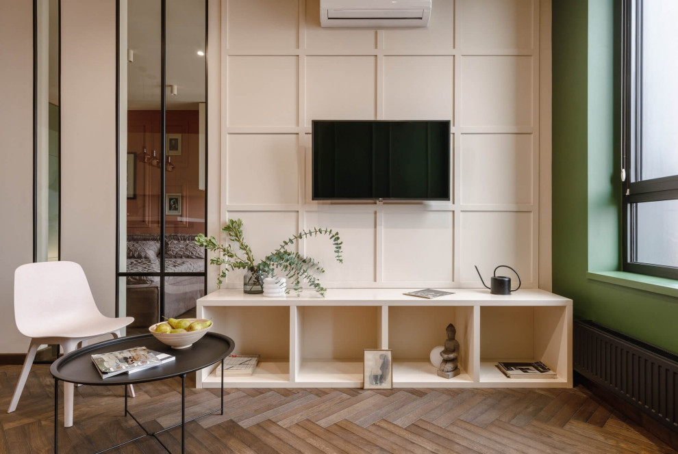Photo of a medium sized contemporary living room feature wall in Moscow with a reading nook, green walls, medium hardwood flooring, no fireplace, a wall mounted tv and brown floors.
