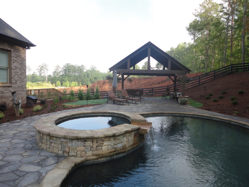 Photo of a large country backyard partial sun garden in Atlanta with natural stone pavers.