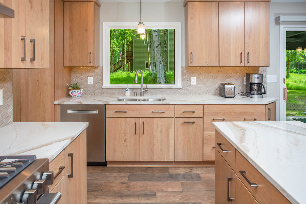 Inspiration for a mid-sized transitional galley eat-in kitchen remodel with flat-panel cabinets, medium tone wood cabinets, quartz countertops and stainless steel appliances