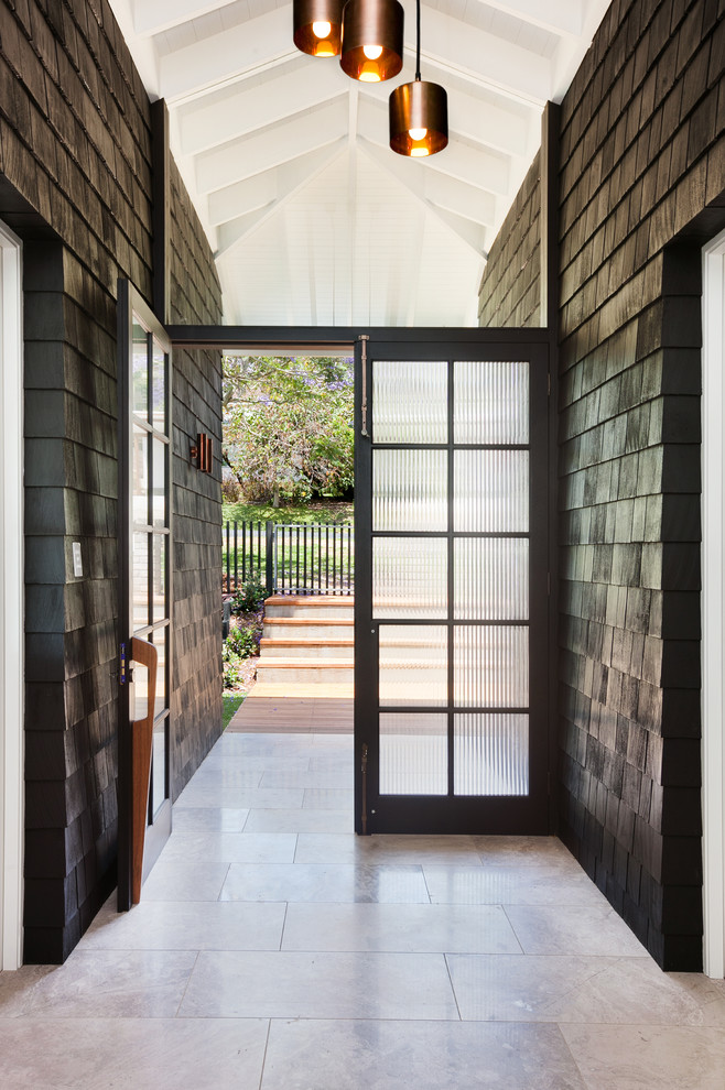 Photo of a contemporary entryway in Central Coast with black walls, limestone floors, a double front door and a glass front door.