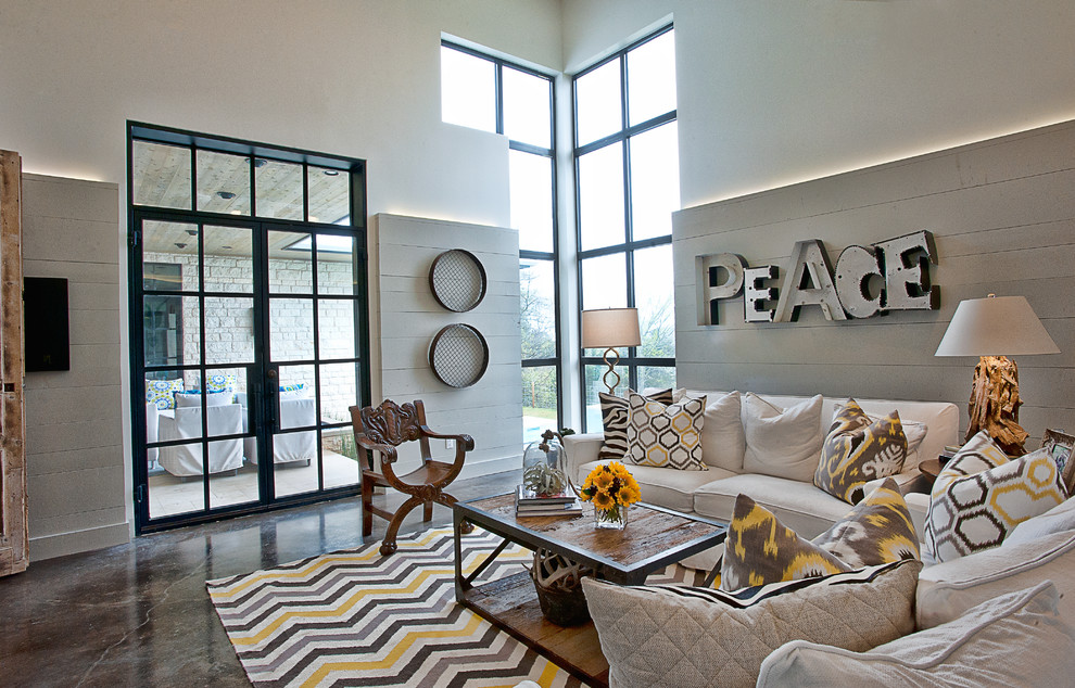 This is an example of a contemporary living room in Austin with concrete floors.