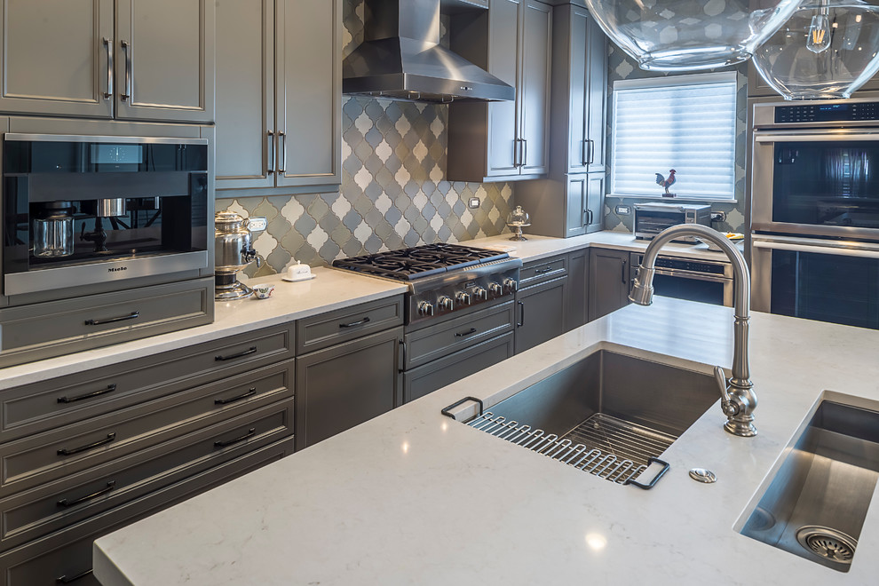 Inspiration for a mid-sized transitional l-shaped dark wood floor eat-in kitchen remodel in Chicago with an undermount sink, recessed-panel cabinets, gray cabinets, granite countertops, multicolored backsplash, porcelain backsplash, paneled appliances and an island