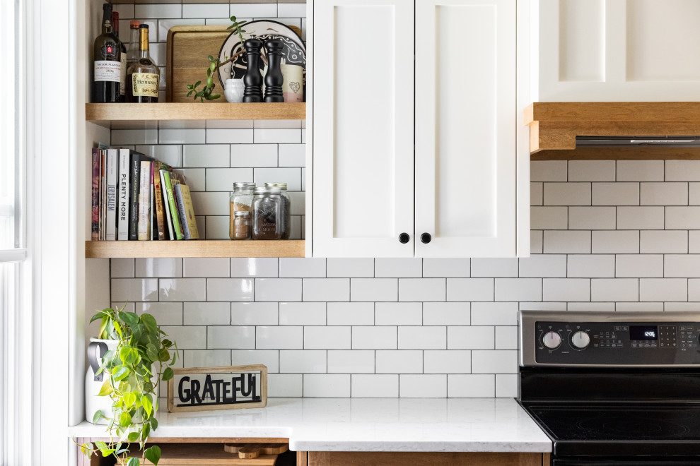 This is an example of a small country galley eat-in kitchen in Calgary with an undermount sink, shaker cabinets, white cabinets, quartzite benchtops, white splashback, subway tile splashback, panelled appliances, terra-cotta floors, with island, grey floor and white benchtop.