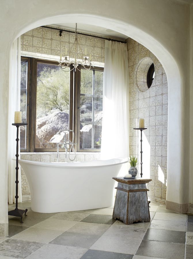 Photo of a mid-sized mediterranean bathroom in Phoenix with a freestanding tub.