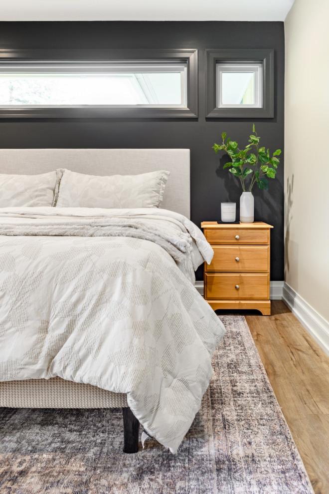 Bedroom - transitional master light wood floor and beige floor bedroom idea in Minneapolis with black walls