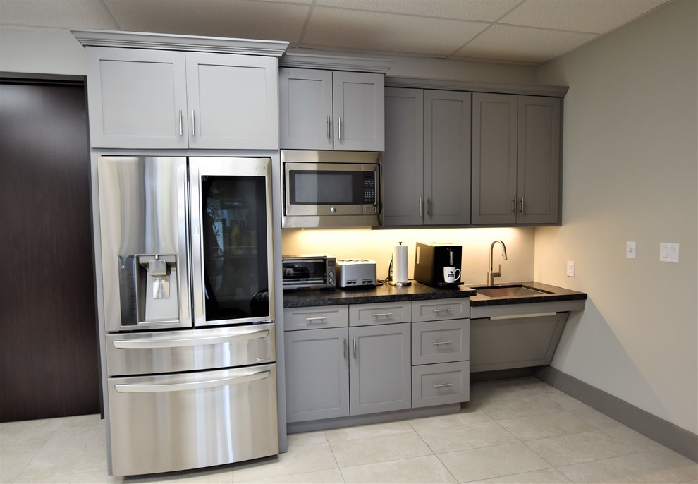 Photo of a mid-sized transitional separate kitchen in Houston with an undermount sink, shaker cabinets, grey cabinets, granite benchtops, grey splashback, porcelain floors, white floor and black benchtop.