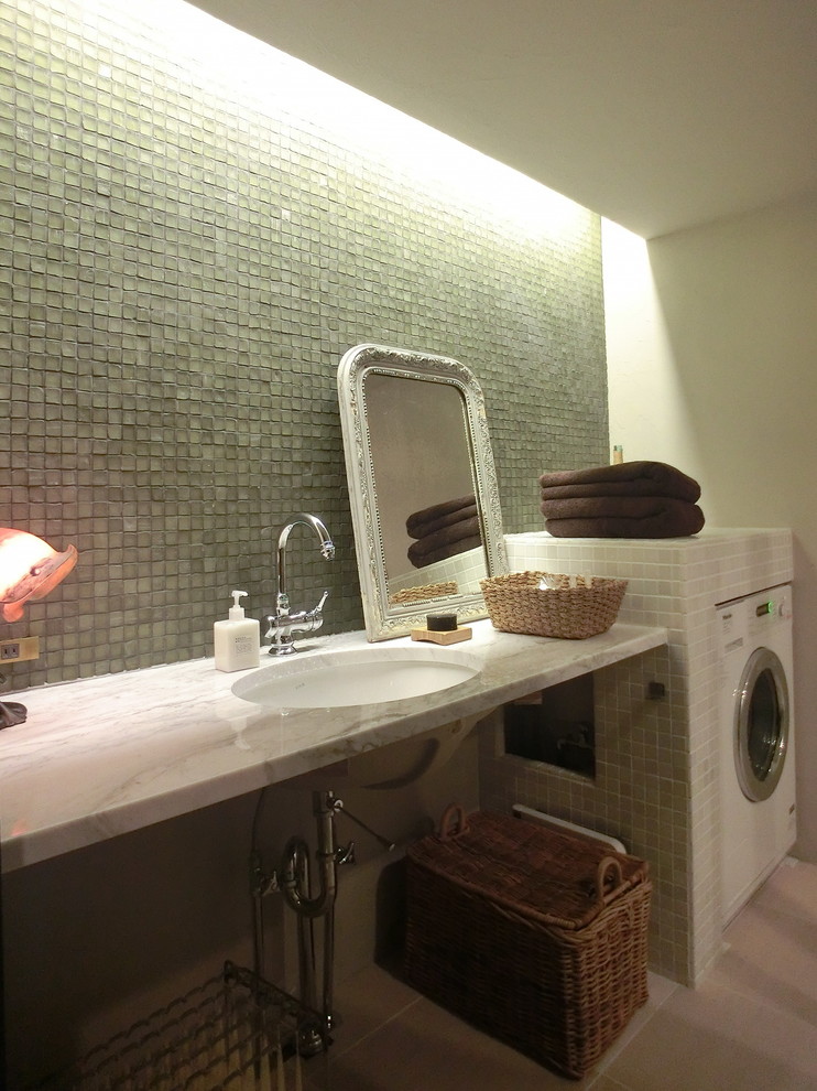 This is an example of a contemporary laundry room in Osaka with green walls.