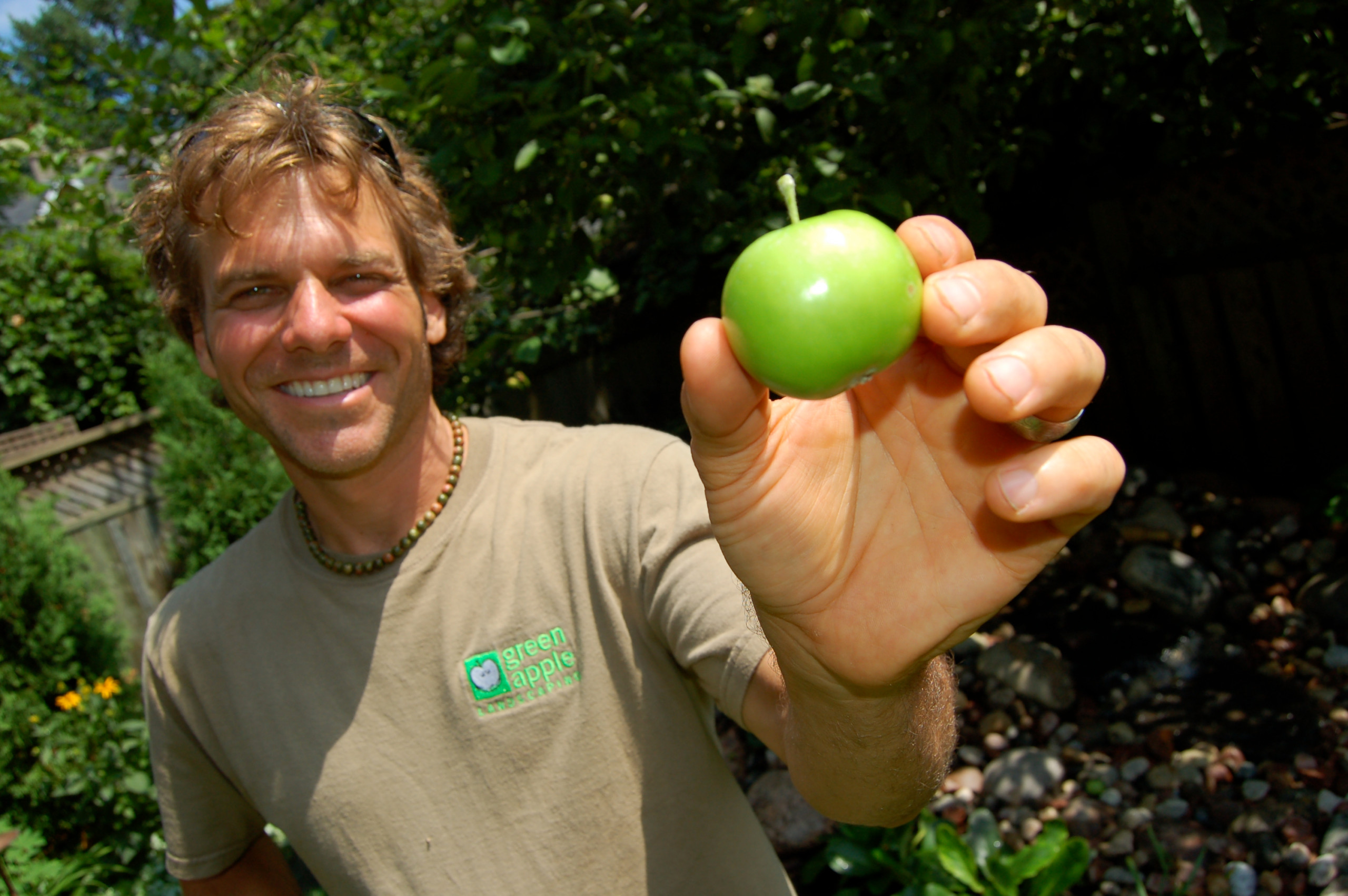 Peter Solti holding a green apple - Green Apple Landscaping