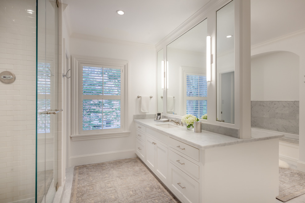 Photo of a large transitional master bathroom in Houston with shaker cabinets, white cabinets, a drop-in tub, white walls, granite benchtops, white tile, subway tile and an undermount sink.