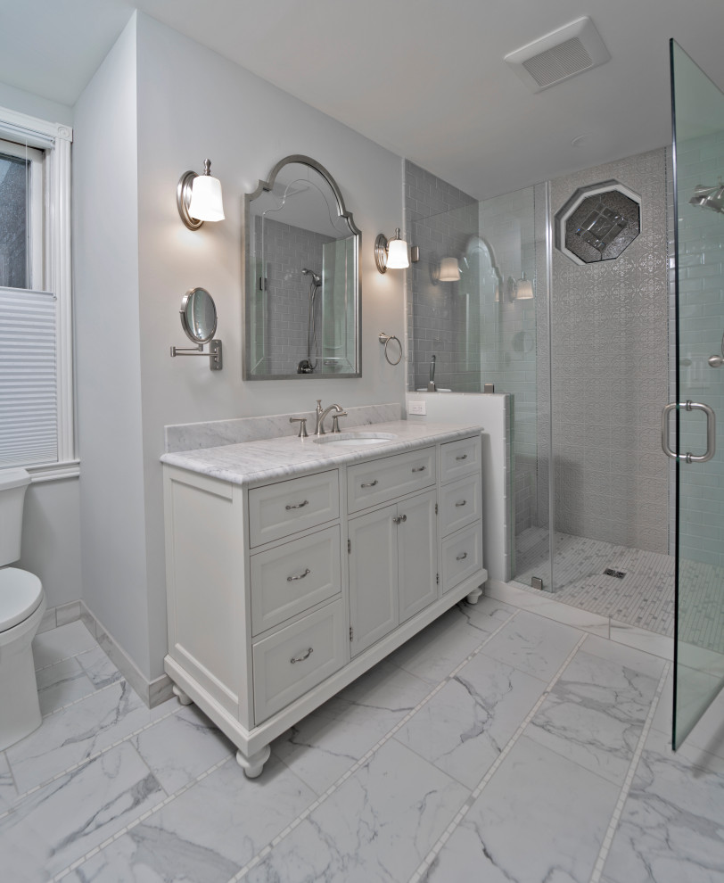 Design ideas for a medium sized victorian ensuite bathroom in DC Metro with recessed-panel cabinets, white cabinets, an alcove shower, a two-piece toilet, blue tiles, ceramic tiles, grey walls, porcelain flooring, a submerged sink, marble worktops, grey floors, a hinged door, white worktops, a shower bench, a single sink and a freestanding vanity unit.