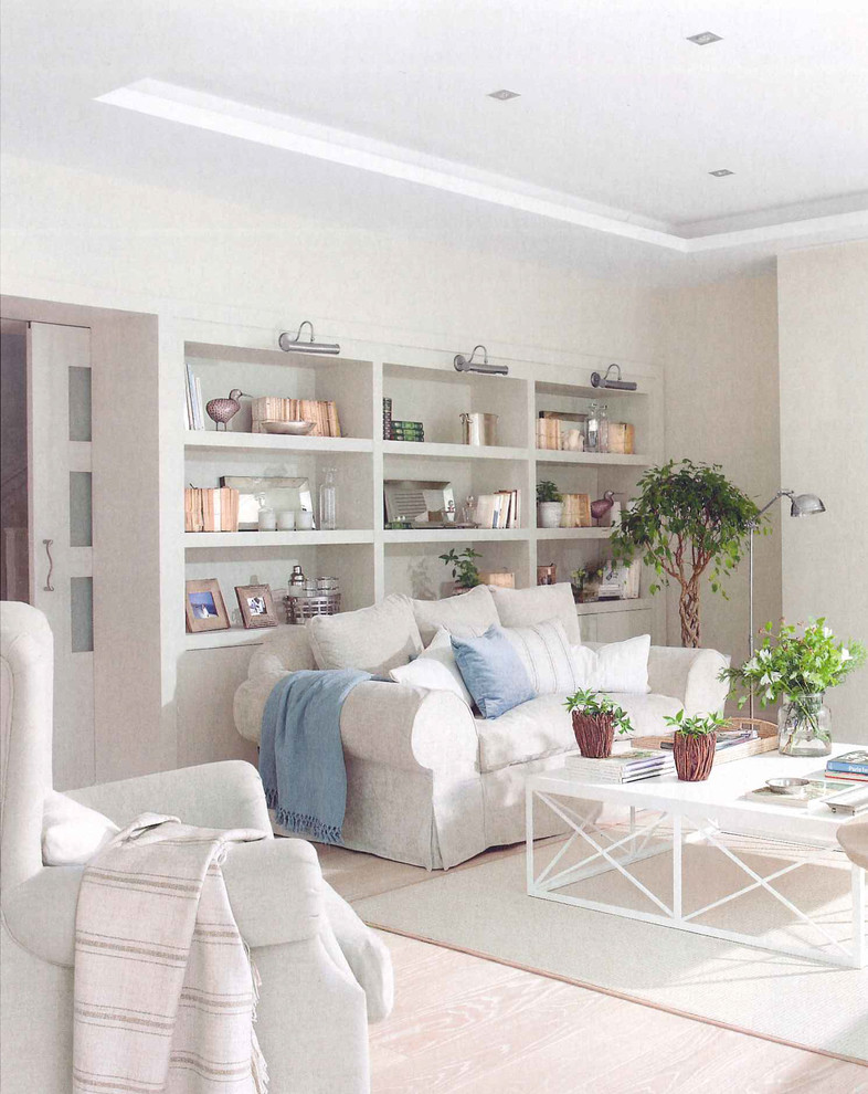 Mid-sized mediterranean formal open concept living room in Madrid with white walls and light hardwood floors.