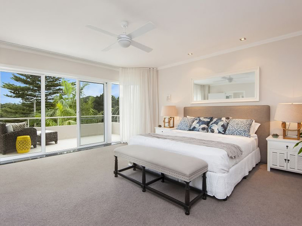 Inspiration for a beach style bedroom in Sydney with beige walls, carpet and no fireplace.