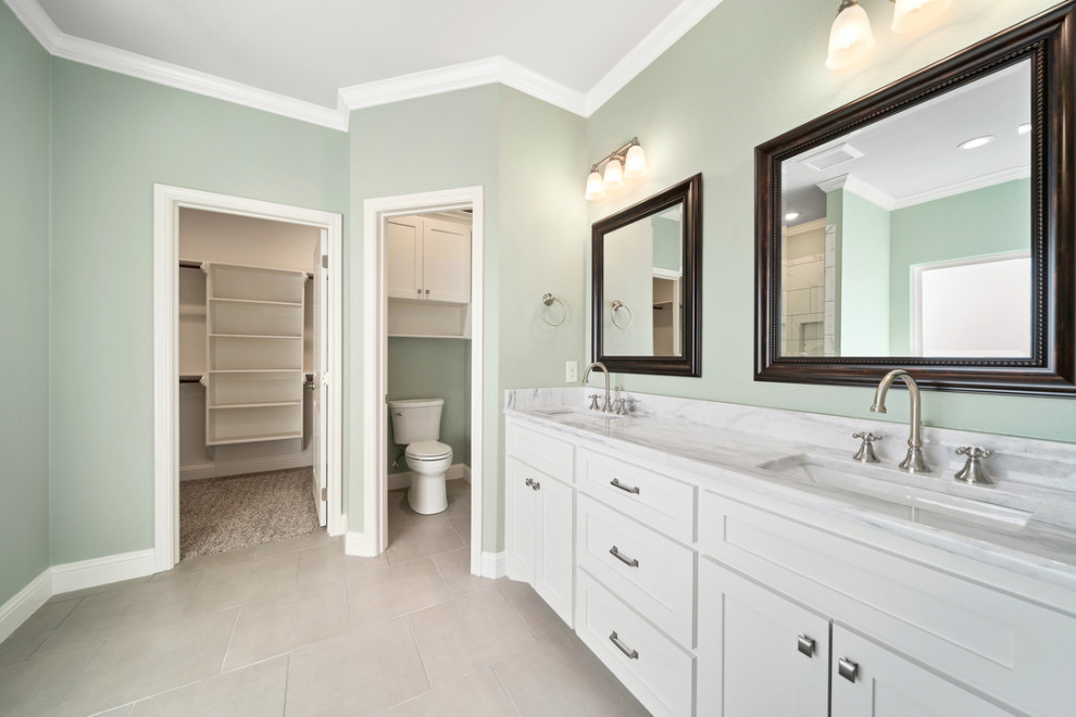 Mid-sized elegant master porcelain tile, gray floor and double-sink bathroom photo in Austin with shaker cabinets, white cabinets, a one-piece toilet, green walls, an undermount sink, granite countertops, gray countertops and a built-in vanity