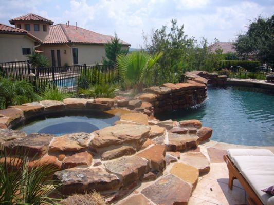 Pool - rustic backyard custom-shaped pool idea in Austin