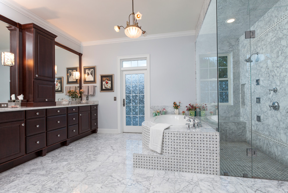 Large traditional master bathroom in Orlando with raised-panel cabinets, dark wood cabinets, a curbless shower, white tile, an undermount sink, marble benchtops, a one-piece toilet, stone tile, purple walls, marble floors and a drop-in tub.