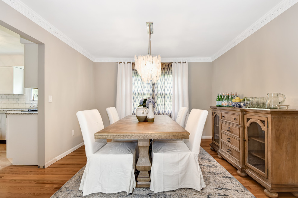 Inspiration for a transitional dining room in New York with grey walls, medium hardwood floors and brown floor.
