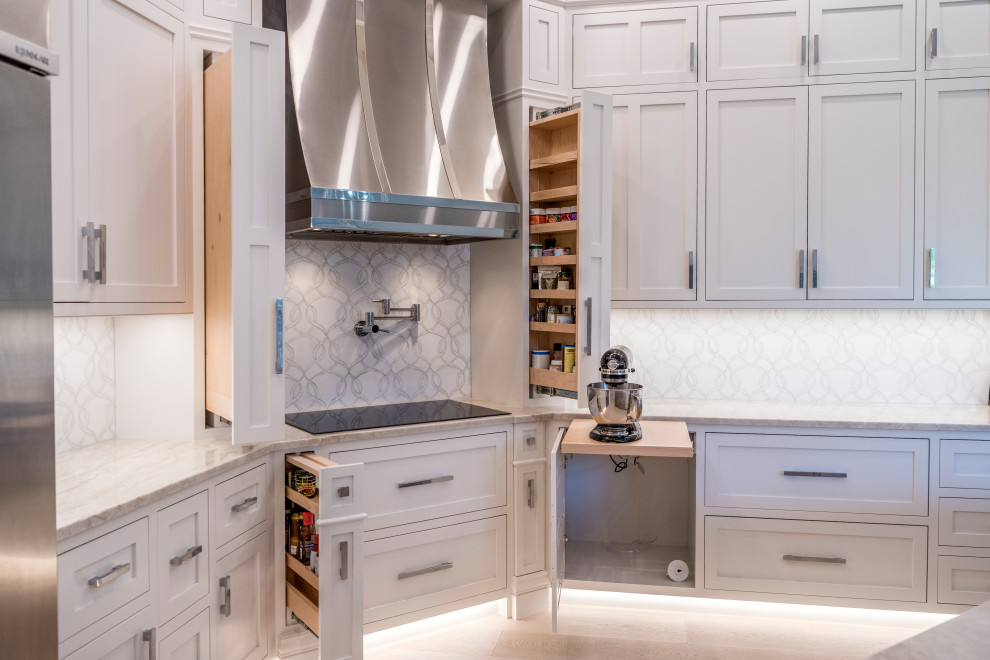 Inspiration for a transitional u-shaped light wood floor, beige floor and coffered ceiling open concept kitchen remodel with an undermount sink, beaded inset cabinets, white cabinets, quartzite countertops, white backsplash, stone tile backsplash, stainless steel appliances, an island and gray countertops