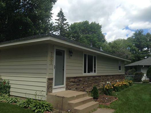 Photo of a mid-sized contemporary one-storey beige exterior in Minneapolis with mixed siding.