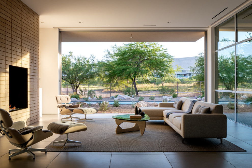 Design ideas for a midcentury patio in Las Vegas with with fireplace and a roof extension.