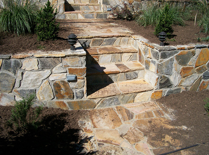 Design ideas for a mid-sized traditional full sun front yard stone driveway in Raleigh for fall.