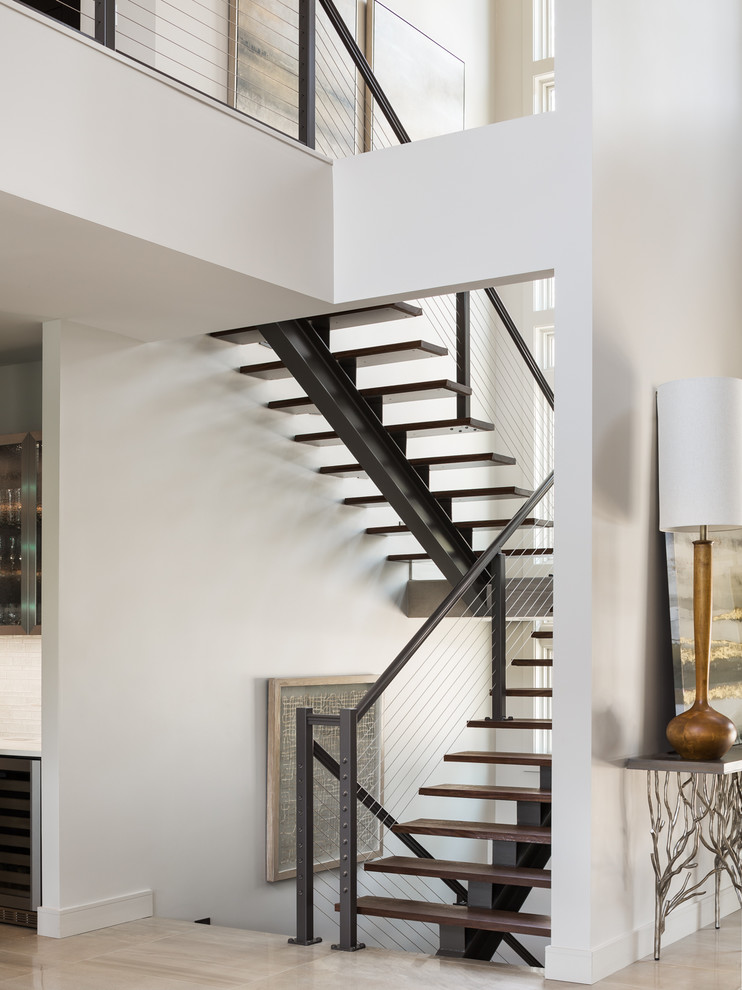 Inspiration for a contemporary wood floating staircase in San Francisco with open risers and cable railing.