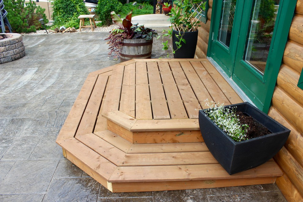 Design ideas for a small country side yard deck in Other with no cover.