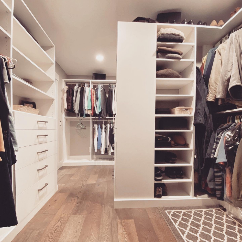 Design ideas for a modern gender neutral walk-in wardrobe in Portland with flat-panel cabinets.