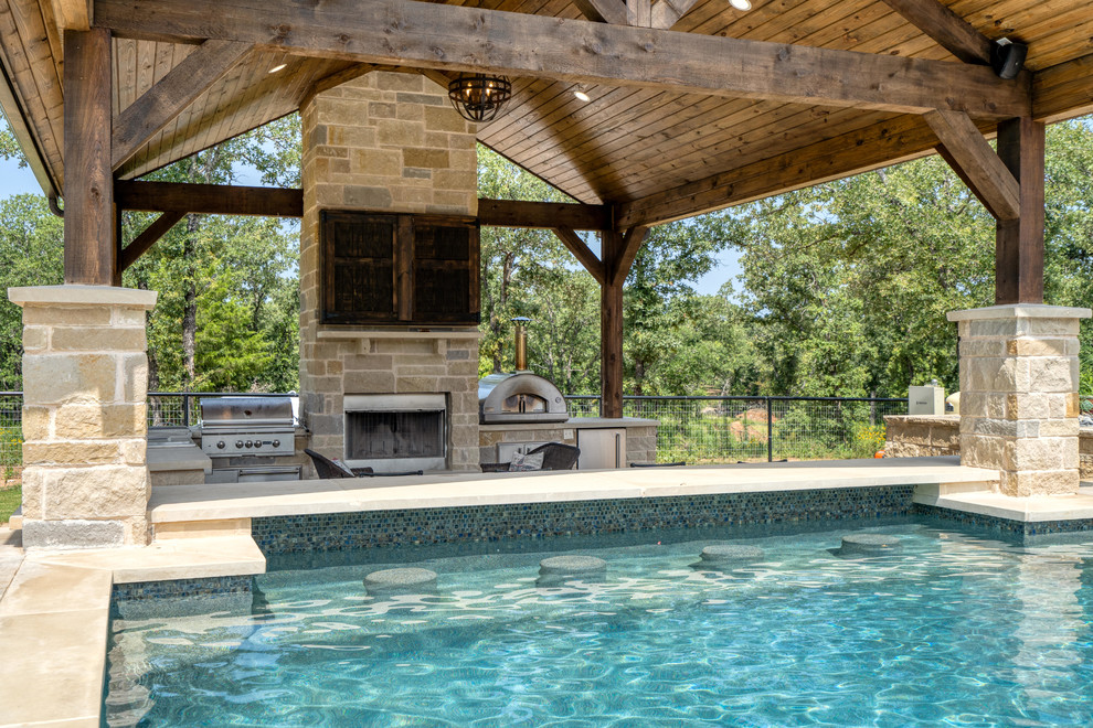 Design ideas for a mid-sized traditional front yard rectangular pool in Dallas with concrete pavers.