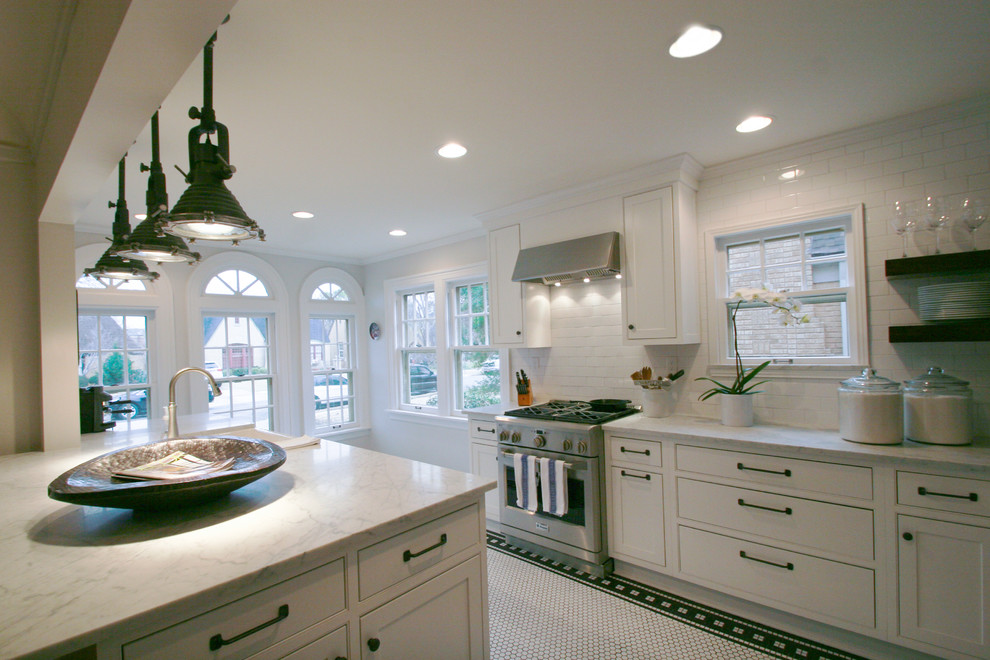 Inspiration for a mid-sized country galley eat-in kitchen in Oklahoma City with a farmhouse sink, flat-panel cabinets, white cabinets, marble benchtops, white splashback, subway tile splashback, stainless steel appliances, ceramic floors, with island, white floor and grey benchtop.
