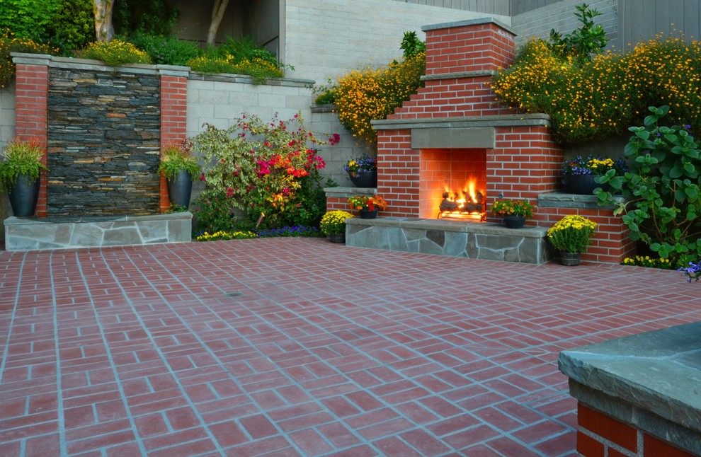 Design ideas for a mid-sized traditional backyard patio in San Diego with a fire feature and brick pavers.
