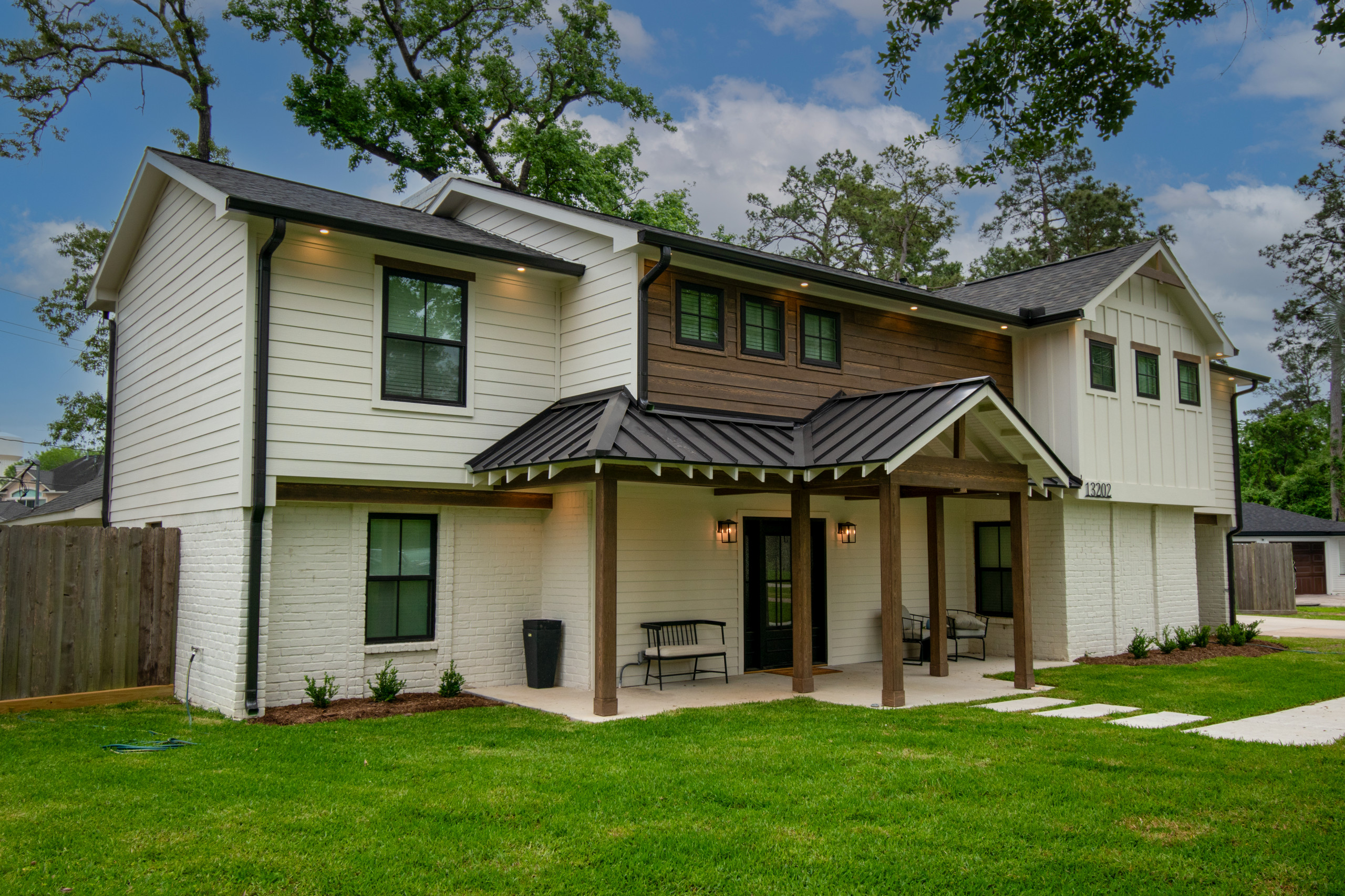 This was a full exterior rebuild due to 1 tree falling on the house and a second tree falling on the garage. The exterior features 4 different types of siding including prefinished stained siding by