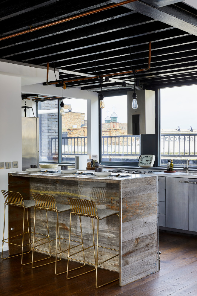 Medium sized industrial galley kitchen in London with an island, flat-panel cabinets, grey cabinets, dark hardwood flooring, brown floors and white worktops.