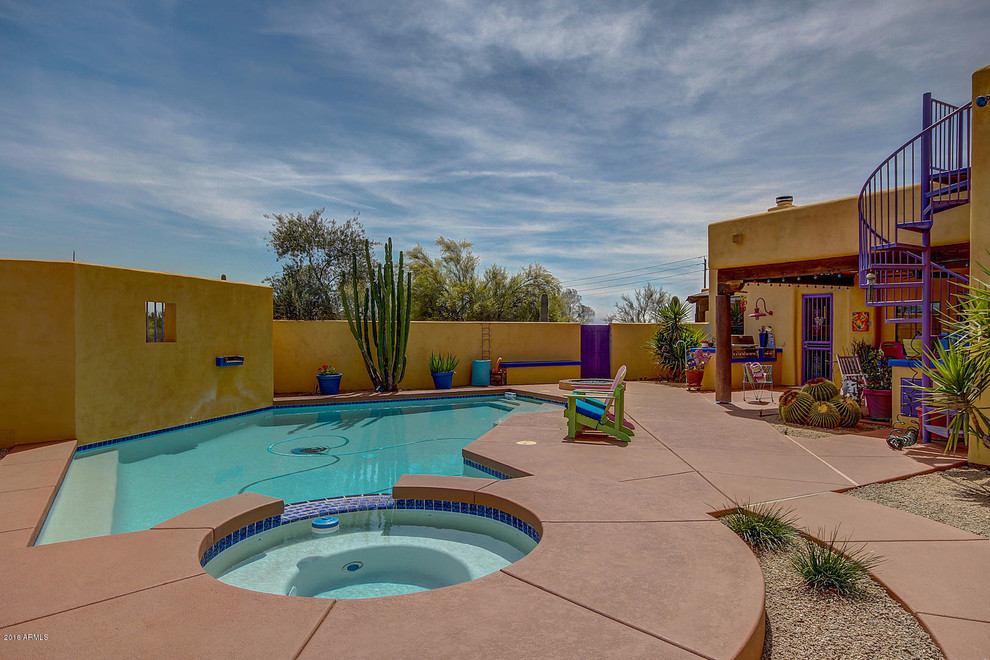 Design ideas for a large backyard custom-shaped pool in Phoenix with a water feature.