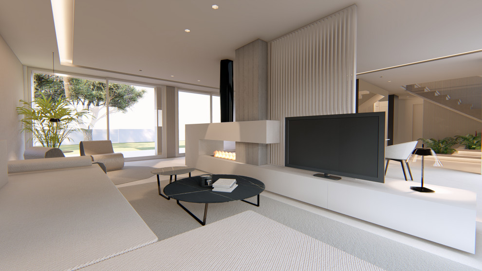 This is an example of a large modern open concept living room in Valencia with multi-coloured walls, limestone floors, a two-sided fireplace, a metal fireplace surround, a freestanding tv, beige floor and panelled walls.