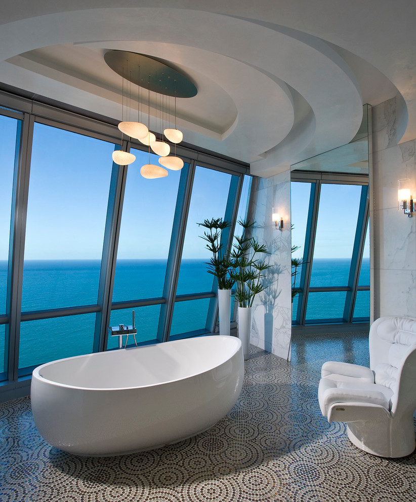 Design ideas for a contemporary bathroom in Miami with a freestanding tub and mosaic tile.