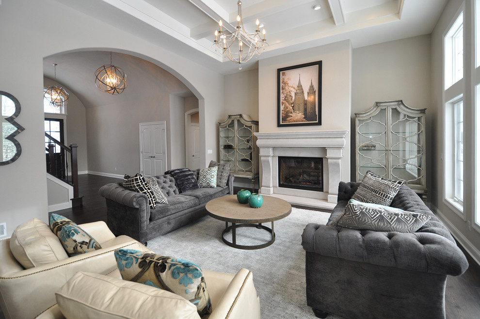 Photo of a mid-sized eclectic open concept living room in Milwaukee with grey walls, dark hardwood floors and a standard fireplace.